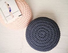 two crocheted poufles sitting next to each other on a white surface