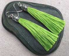 "Chic lime green tassel earrings! They would add a pop of color to any outfit for any occasion. Dress them up or down. They are timeless and versatile. They are lightweight, fun and unique! The tassels measure 2 1/8\" long by 1/4\" wide. They hang from simple silver ear wire hooks. Overall drop length is about 2 1/4\". Metal is allergy free plated silver. These are my latest creation! I have them available in many colors! Find them all under the category tassel earrings in my shop. Thanks for st Green Dangle Tassel Earrings For Pierced Ears, Green Beaded Tassel Drop Earrings, Green Tassel Drop Earrings As Gift, Green Tassel Earrings For Gift, Green Statement Earrings, Green Tassel Earrings, Bali Earrings, Green Jewelry, Unique Jewelry Designs