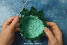 someone is crocheting a green bowl with yarn