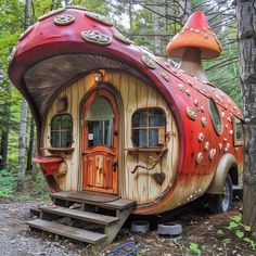 an unusual looking house in the woods