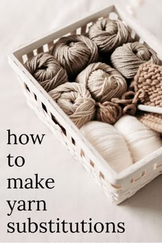 a basket filled with balls of yarn and knitting needles