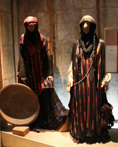 two mannequins dressed in traditional clothing on display