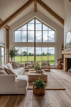 a living room filled with furniture and large windows