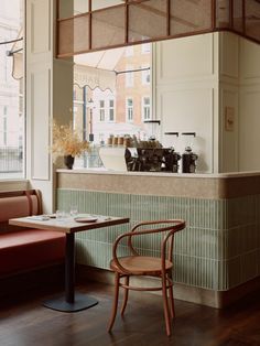 the interior of a restaurant with tables and chairs