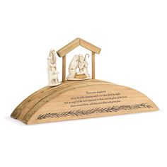 a wooden nativity set on top of a hill with an image of the birth of jesus