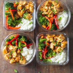 four plastic containers filled with rice and veggies on top of a wooden table