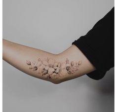 a woman's arm with flowers on it