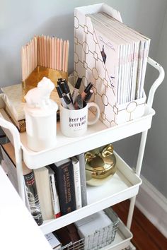 a white shelf with books and other items on it