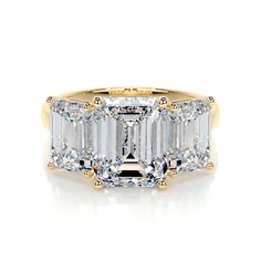 an emerald cut diamond ring with three baguets on the side and two sides