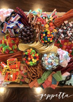 a wooden tray filled with candy and candies