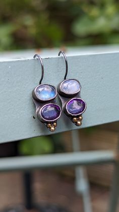 Beautiful handmade earrings made by me from bezel set  Moonstones and oval Amethysts. I used recycled Sterling Silver and I applied 23.5k gold foil to silver balls, using Keum Boo technique. I oxidised silver using traditional technique to make stones to stand out. The design is very cute for everyday use as the earrings are very lightweight, comfortable to wear all day, not too large. The total length is 30mm, 8mm at the widest point. Everything I sell is made by me here in Wiltshire.  I will p Artisan Purple Amethyst Jewelry, Artisan Amethyst Silver Jewelry, Silver Amethyst Dangle Earrings, Keum Boo Earrings, Artisan Purple Drop Earrings, Keum Boo, Present For Her, Small Gift Boxes, Presents For Her