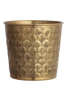 a large brass planter on a white background