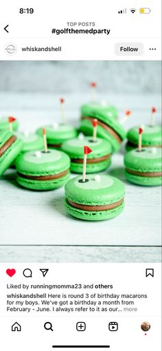 some green cupcakes with red and white pins on them are sitting next to each other