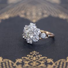 Super charming, super beautiful, and incredibly sparkly antique cluster ring, set wit the chunkiest and most lively old cut diamonds! The central diamond is showcased stunningly well in the surround of chunky old mine cut diamonds. In yellow gold, all the diamonds just pop! Low set on the finger, this ring is ideal for daily wear, and what a stunning and unique engagement ring this would make. Just a classically styled ring from the Victorian era. 14kt yellow gold, size 7.50, and fully sizable. Cluster Rose Cut Diamond Ring For Anniversary, Cluster Diamond Ring With Rose Cut For Anniversary, Vintage White Cluster Ring With Rose Cut Diamonds, Antique Cluster Diamond Ring With Rose Cut Diamonds, Victorian Cluster Ring With Diamond Accents In Diamond White, Vintage Marquise Cluster Ring In Diamond White, Antique White Cluster Ring With Brilliant Cut, Heirloom Diamond White Cluster Ring, Cluster Diamond Ring With Rose Cut Diamonds