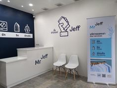 an office with two white chairs and a sign on the wall that says mr jeff