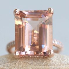 This Diamond Prong Morganite Ring is part of our Olivia Collection, which is characterized by a gorgeous, genuine gemstone with Golden Hearts under it. Diamonds stud the hidden halo and sparkle down the half eternity shank. Custom initials at the back of the shank are available on all rings upon request! Center Stone: Genuine AAA Peachy Pink Morganite, Emerald Cut, averaging 15x12mm and 10 carats. Side Stones: 68 Diamonds - you choose Lab Grown or Organic - averaging F-G, VS2-SI1 and 0.46 carats Morganite Radiant Cut Jewelry For Anniversary, Radiant Cut Morganite Rings For Anniversary, Radiant Cut Morganite Wedding Jewelry, Timeless Crystal Gemstone Ring For Anniversary, Dazzling Radiant Cut Gemstone Ring, Classic Morganite Jewelry With Prong Setting, Rose Gold Octagon Ring With Prong Setting, Rose Gold Octagon Jewelry With Prong Setting, Morganite Center Stone Jewelry For Anniversary