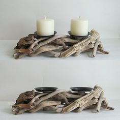 two candle holders made out of driftwood with candles on them, one is white and the other is black