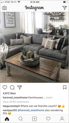 a living room with grey couches and pillows on top of the coffee table is featured in instagram