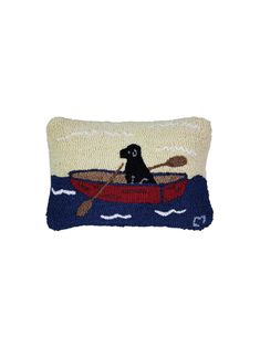 a pillow with a dog in a boat on the water