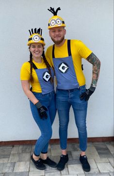 a man and woman dressed up in minion costumes, standing next to each other