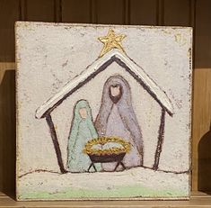 a nativity scene with a baby jesus in the manger, and a star above it