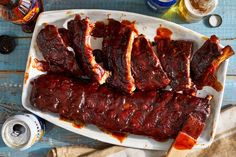 ribs on a platter with sauce and condiments