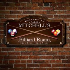 a brick wall with a sign for billiard room and pool balls hanging on it