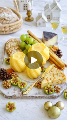 an assortment of cheeses and crackers on a platter