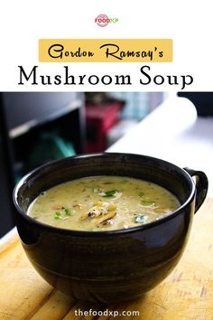 a bowl of mushroom soup sitting on top of a wooden table