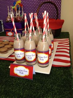 there are some cookies and milk in the bottles on the table with candy canes