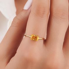 About this item Introducing the exquisite Gold Citrine Ring in Real Gold, designed to captivate with its stunning allure and timeless elegance. Crafted with utmost precision, this exquisite piece is perfect for those seeking a symbol of eternal love and commitment 𝐈𝐭𝐞𝐦 𝐃𝐞𝐭𝐚𝐢𝐥𝐬 * Gold KT: 10K, 14K, 18K * Custom Gold Color: Rose Gold, Yellow Gold, White Gold * Width of Band: 1.52MM * Thickness of Band: 0.88MM 𝐆𝐞𝐦𝐬𝐭𝐨𝐧𝐞 𝐃𝐞𝐭𝐚𝐢𝐥𝐬 * Citrine * Total CTW: 0.35ctw WHY COSMIC FINE JEWELRY? ✓ Crafted with precision by skilled artisans with 10 years of experience in fine jewelry craftsmanship ✓ Uncompromising on quality to ensure customer satisfaction with every piece ✓ Exudes elegance and sophistication, perfect for special occasions or everyday wear ✓ Thoughtfully packaged i Elegant Rectangular Citrine Ring, Minimalist Citrine Jewelry Gift, Citrine Ring With Rectangular Stone For Gift, Classic Citrine Rectangular Jewelry, Octagon-shaped Citrine Jewelry For Anniversary, November Birthstone, 18k Gold Ring, Citrine Ring, Luxury Jewelry