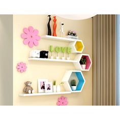 two white shelves with flowers and pictures on them, one has the word love above it