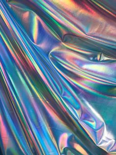 an iridescent background with many different colors and patterns on it, including metallic foil