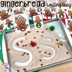 the gingerbread letter s is displayed in front of a sand tray with pictures of gingerbreads