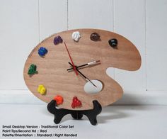 a wooden clock with different colored candies on it's face, and hands