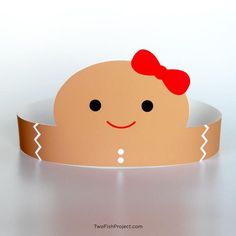 a paper cut out of a baby's head with a red bow