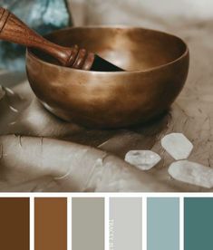 a wooden spoon sitting on top of a metal bowl