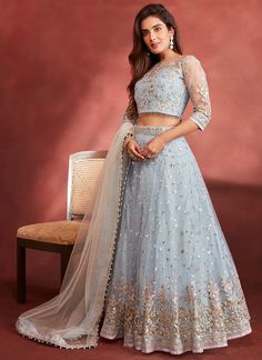 Dusty Blue Embroidered Net Lehenga features a net blouse and lehenga with santoon inner alongside a net dupatta. Zari, thread and stone embellishments are used for the embroidery of this style.  Like all of our pieces, this piece is made in India and checked by hand to ensure high quality. Anarkali Set For Reception During Navratri, Party Wear Gown With Resham Embroidery And Net, Party Wear Gown With Resham Embroidery In Net, Bollywood Embellished Gown, Bollywood Style Embellished Net Gown, Festive Net Gown With Sheer Dupatta, Eid Lehenga With Intricate Embroidery In Net, Eid Net Lehenga With Intricate Embroidery, Eid Lehenga With Intricate Embroidery On Net