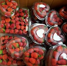 strawberries are arranged in plastic containers and placed on top of each other for sale