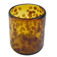 a brown and black glass vase with dots on it