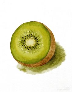 a kiwi cut in half sitting on top of a table