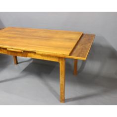 a wooden table with two drawers on one side and an open drawer on the other