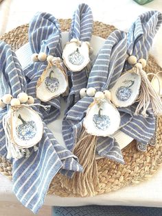 some blue and white dishes are on a wicker plate with tassels around them