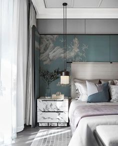 a bedroom with a bed, nightstand and wallpapered walls in shades of blue