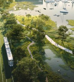 an aerial view of a river with boats in the water and people walking along it