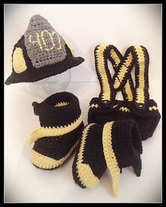 crocheted hats, mittens and booties are displayed on a white surface