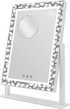 a white mirror with black and white designs on the front, along with a stand