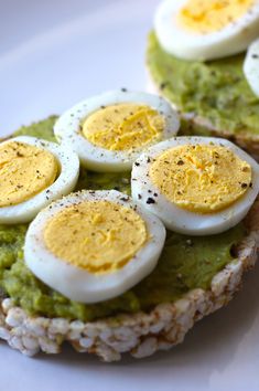 an open face sandwich topped with eggs and avocado