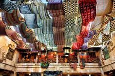 the ceiling is covered with many different colored fabrics