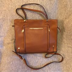 Make An Offer! This Steve Madden Tote Is Perfect For Office/Work. Brand New, Never Used Nutmeg Brown Faux Pebbled Leather Bag Features Secure Zip Closure At Top, Top Handles, And Removable And Adjustable Shoulder/Cross-Body Strap. Two (2) Main Inside Compartments: One W/ 2 Small Pockets For Pens, Phone, Etc. + 1 Slim Zip Pocket; One W/ Slim Zipper Pocket. Front Features 3 Slim External Pockets (2 W/ Zippers). Easily Fits Laptop And So Much More! Excellent Condition. Note: One Minor Flaw. Small H Brown Shoulder Bag With Zipper For Work, Brown Zipper Closure Shoulder Bag For Work, Brown Satchel With Zipper For Work, Brown Satchel With Zipper Closure For Work, Brown Tote Satchel With Gunmetal Hardware, Brown Leather-handled Tote Briefcase, Cognac Leather-lined Tote Satchel, Dark Tan Leather-lined Tote Bag, Cognac Shoulder Tote Bag With Gold-tone Hardware